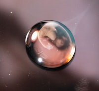 a drop of water with a reflection of a person