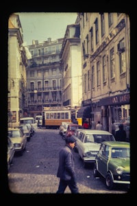 a man walking down a cobblestone street
