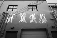 shadows of people on a building