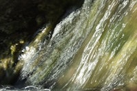 a close up of a waterfall in a rocky area