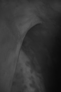 a black and white photo of a curved wall