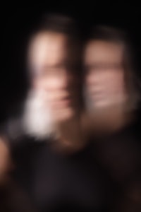 a blurry image of two people on a black background