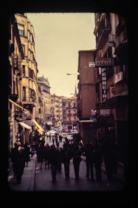 a group of people walking down a city street