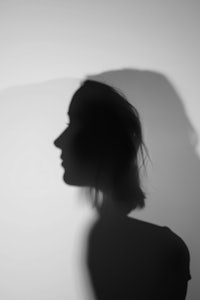 a silhouette of a woman is shown against a white background